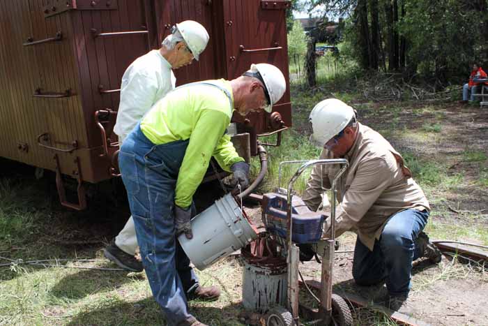 6.20.19 The paint crew gets red paint into the spray pump bucket (1 of 1).jpg