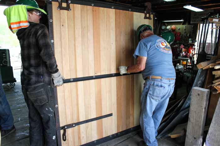 2019.06.21 One of the new door to 5553 is placed on the floor of the woodshop showing the outside hardware  (1 of 1).jpg