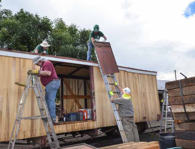 2019.07.29 Passing the new cladding up to the roof to be installed (1 of 1).jpg