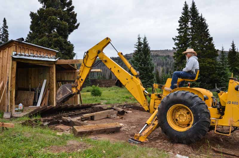 2019.08.01 Using the backhoe to pull up the walkway between the house and out buildings (1 of 1).jpg