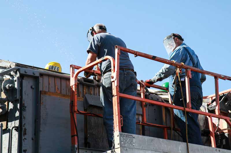 2019.08.24 Two members are on the man lift working on the roof of the OY (1 of 1).jpg