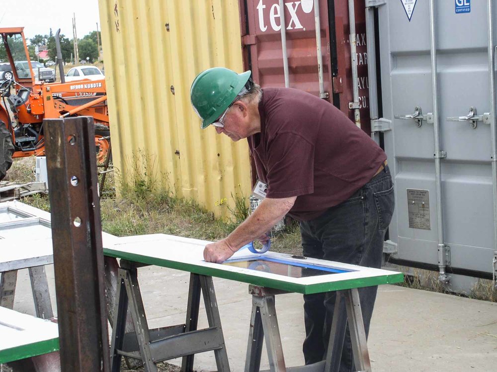 2019.09.23 Taping the glass in one of the OY doors before painting begins (1 of 1).jpg