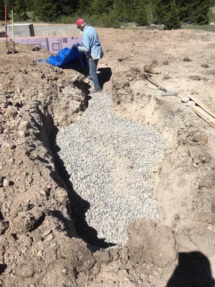 3 Looking at thow the drain field is being prepared using stones and gravel.jpg