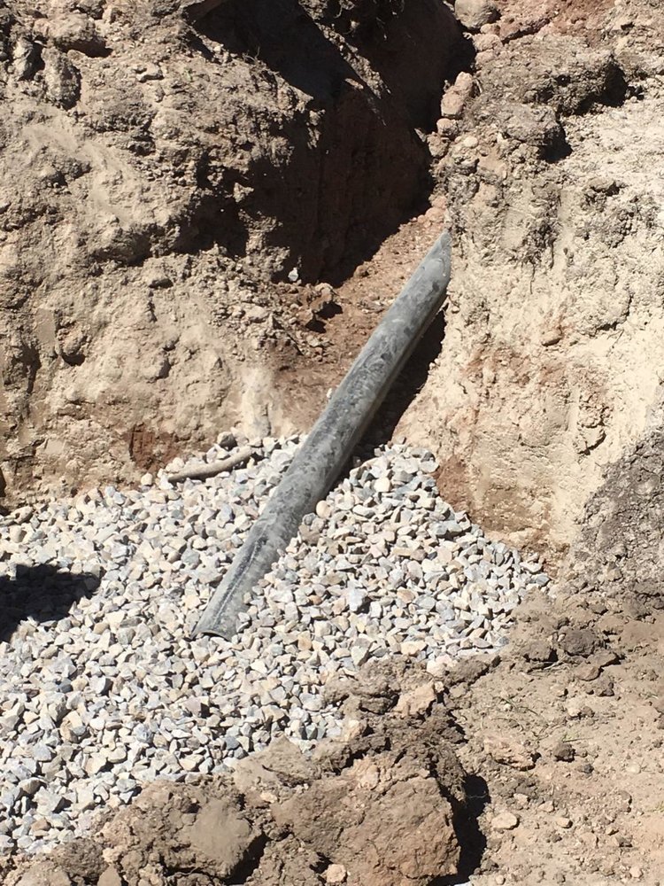 A close shot of how the drain pipe fit into the drain field.jpg