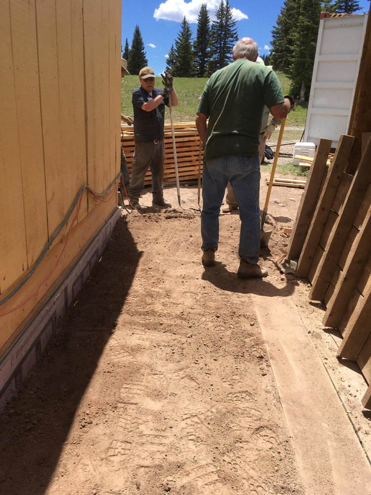 Working on the dirt around the foundation of the house.jpg