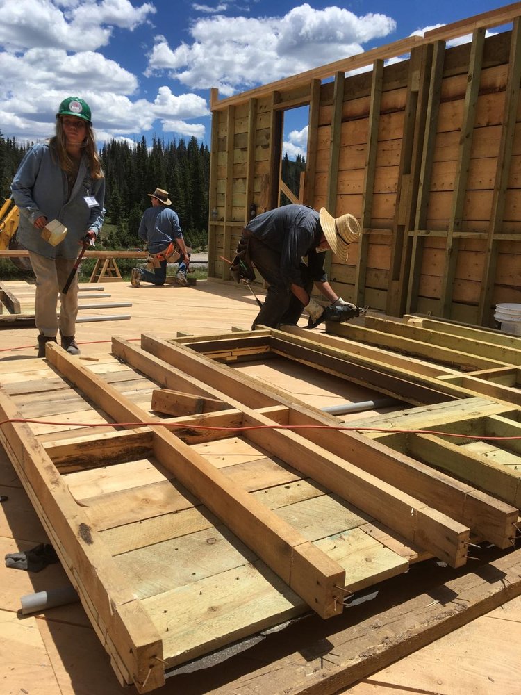 Crrew working on one of the walls getting it ready to put back into place.jpg