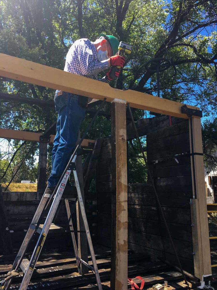 Drilling into the top frame also showing the cross bracing as well as the temporary strap support on the end. (1 of 1).jpg