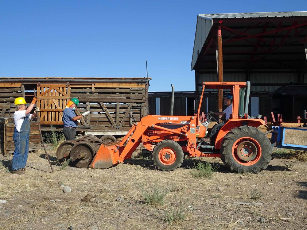 Using the loader to pick up wheels that will be used.jpg