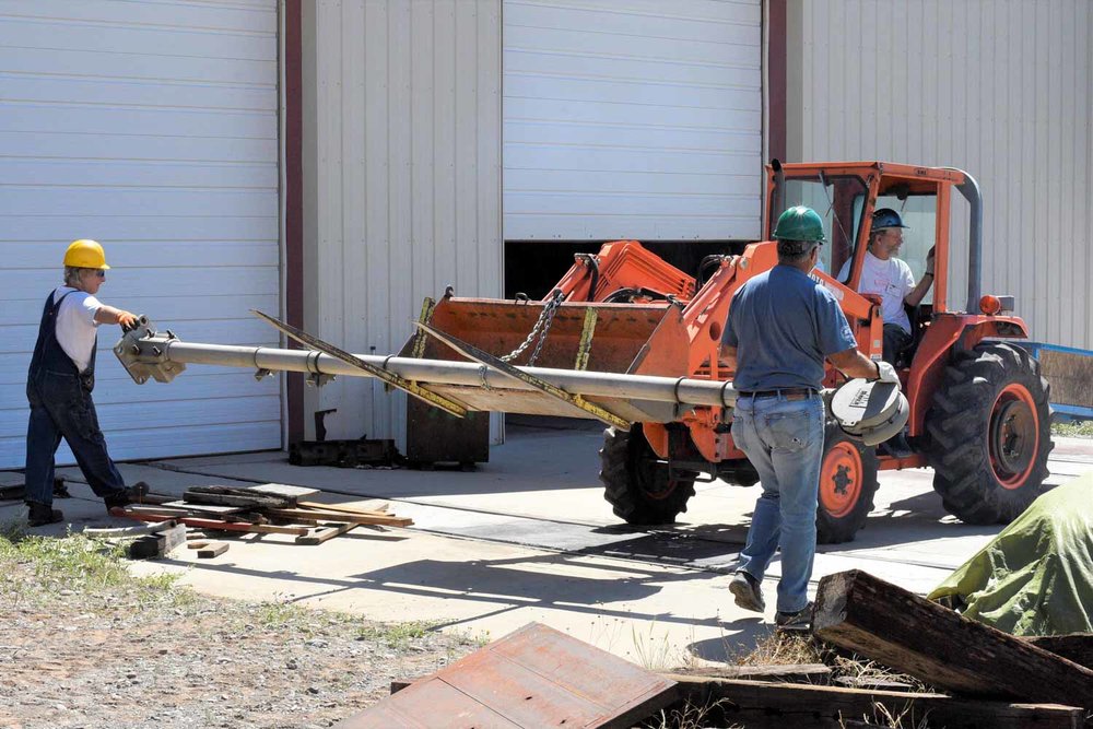 The loader with a 2 man assist is moving a piece of equipment (1 of 1).jpg