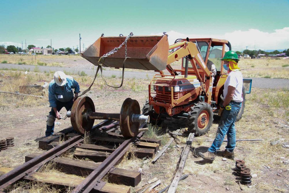 Hooking up the chains to the wheel set so the loader can pick it up (1 of 1).jpg