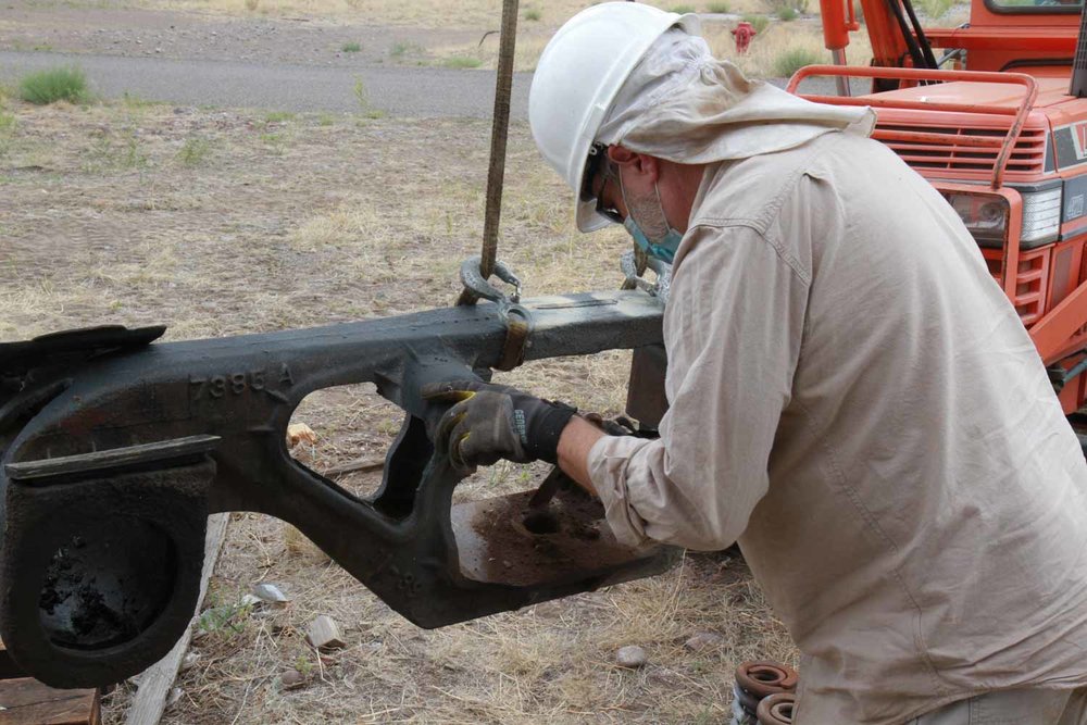 A side bolster is hoisted up while the Friend is scraping off some rust (1 of 1).jpg