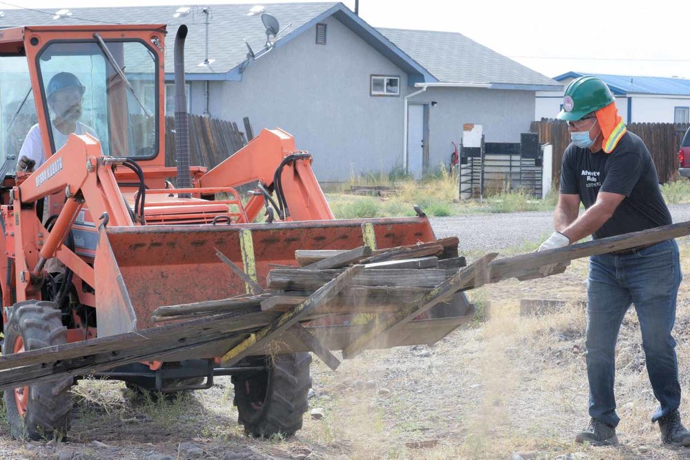 Pilling up old wood in the bucket of the loader (1 of 1).jpg