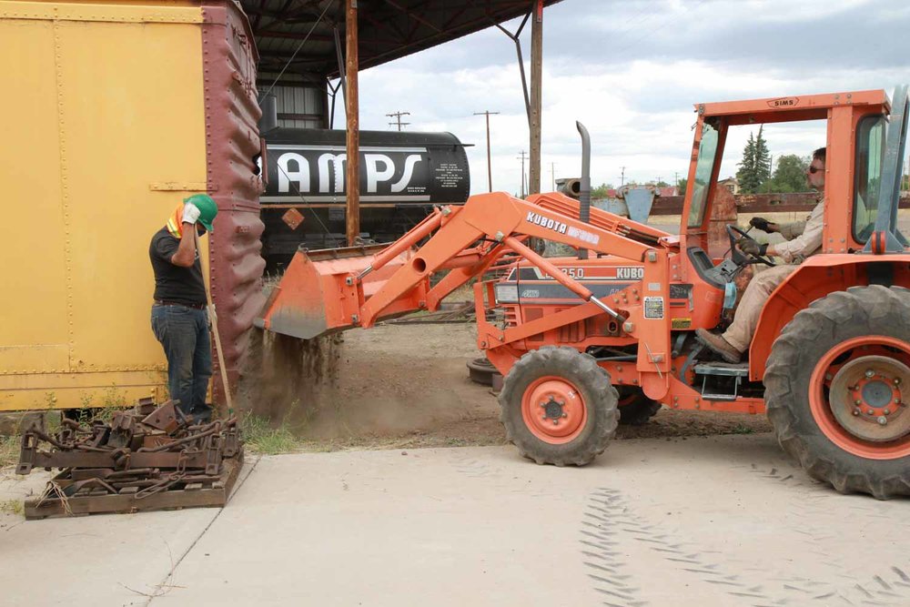 The loader dumps more dirt to assist in leveling the area around the wheel press (1 of 1).jpg