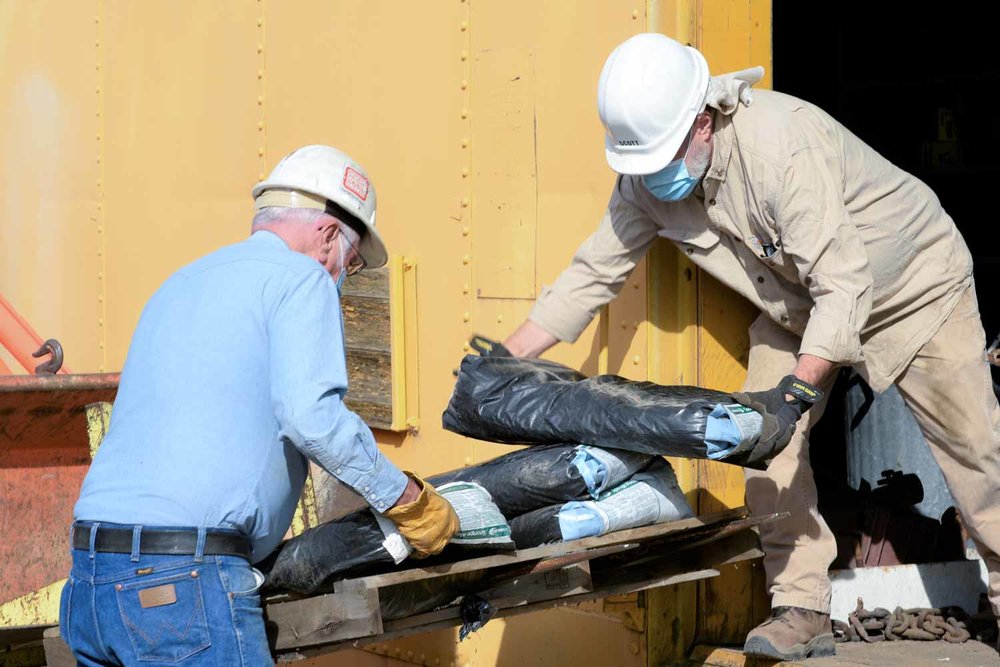 Taking bags out of one of the storage box cars (1 of 1).jpg