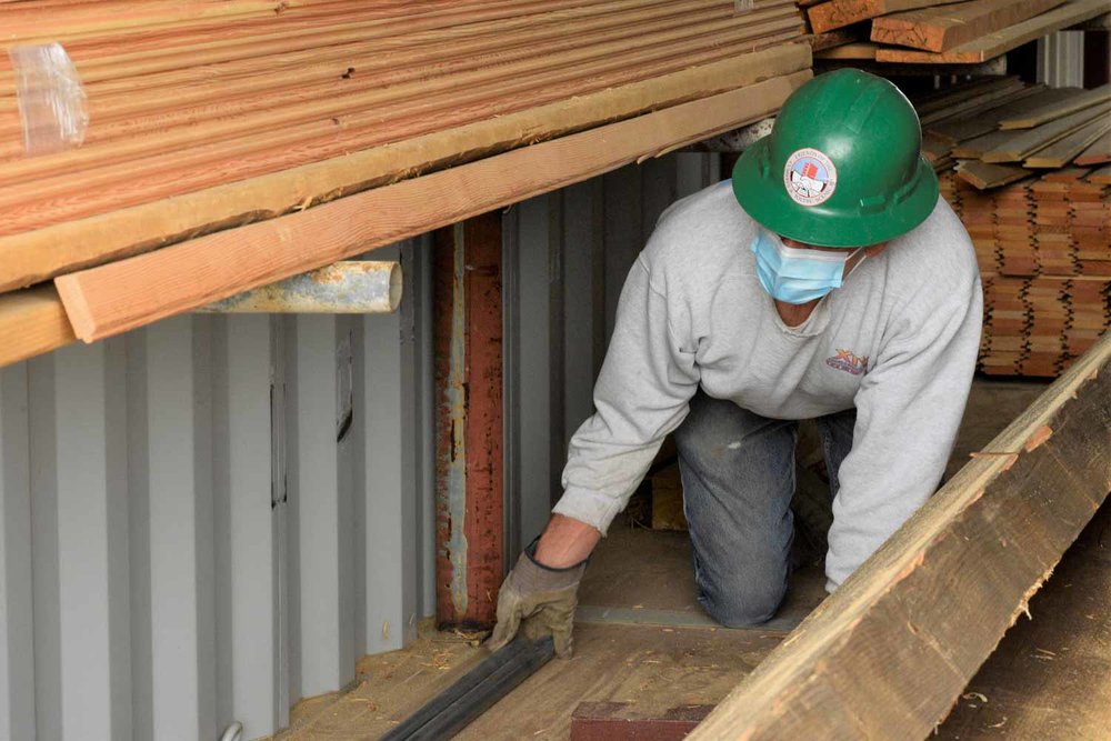 Looks like he is placing a spacer to hold the wood off the deck (1 of 1).jpg