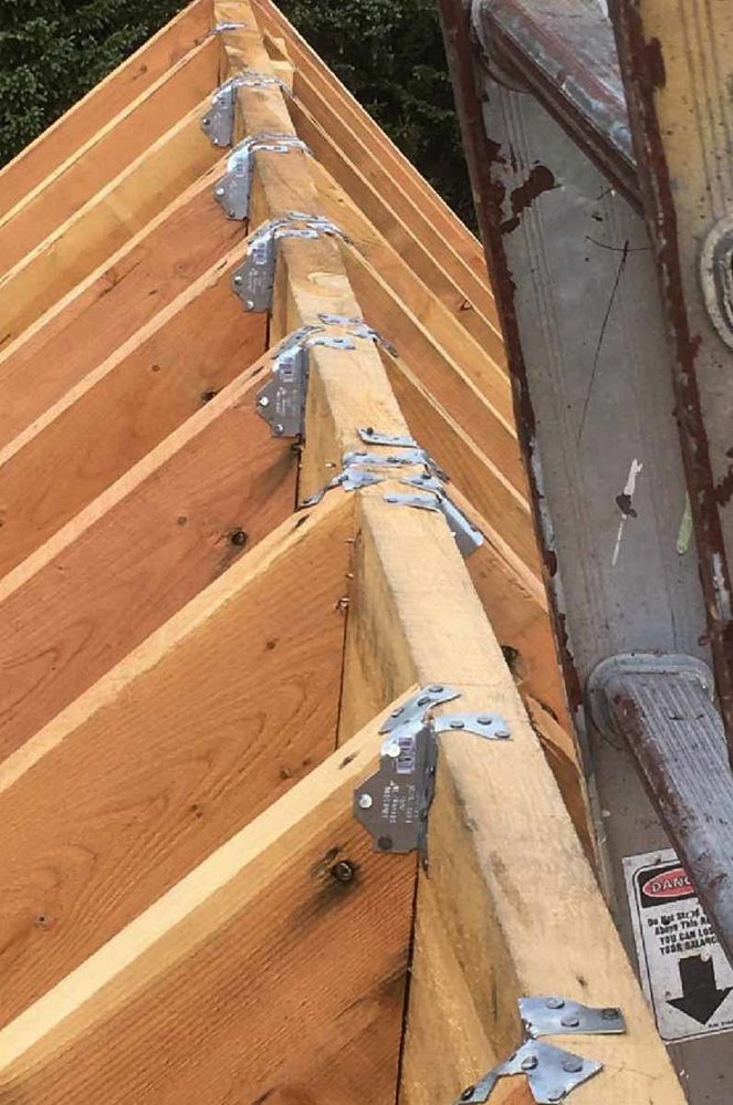 Nice close up showing the straps used to hold the rafters to the center beam (1 of 1).jpg