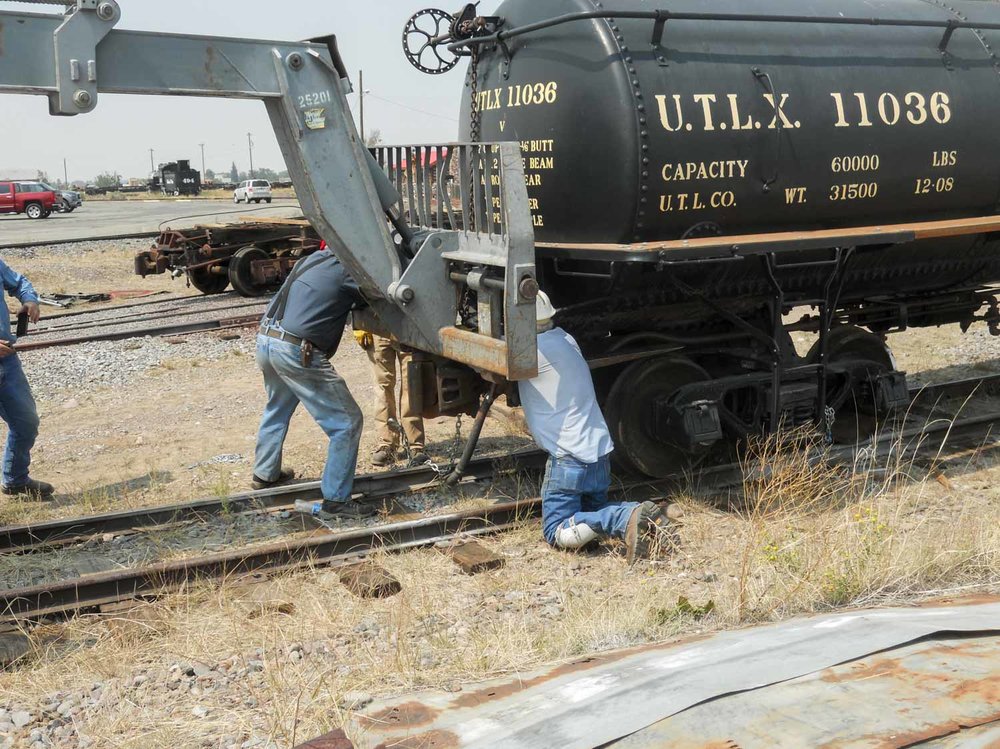 The loader has come in and is getting ready to lift the tank car off its old truck (1 of 1).jpg