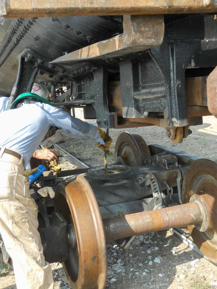 Greasing the bearing plate of the truck before the car is set back down (1 of 1).jpg