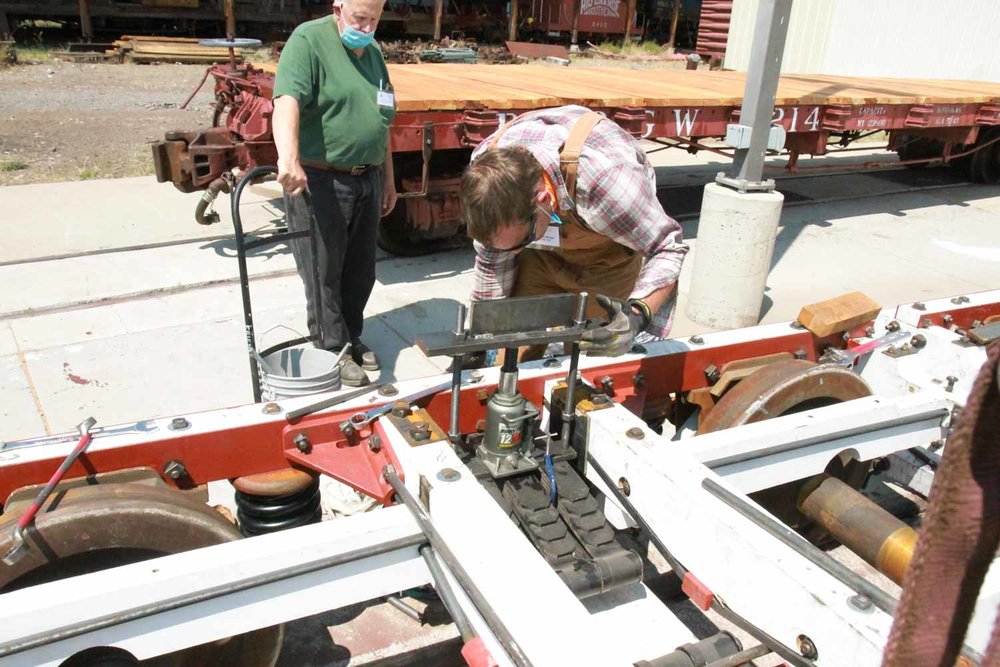 Using a portable press to work on one of the vintage passenger car trucks (1 of 1).jpg