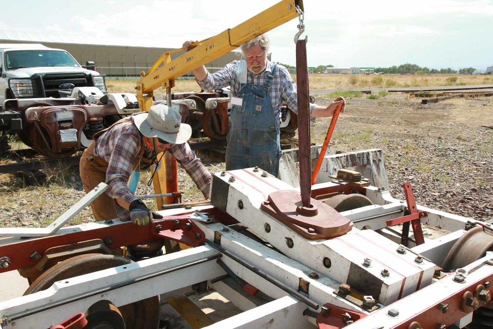 Using the small shop lift to lower a section into the passenger car truck (1 of 1).jpg