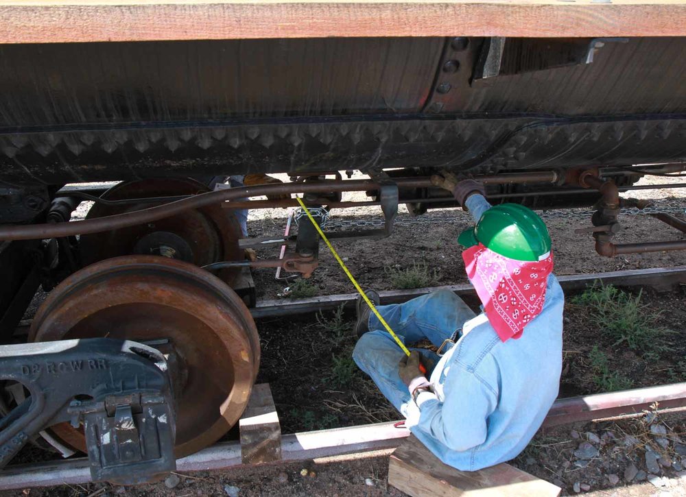 Working on the brake rigging under one of the tank cars (1 of 1).jpg