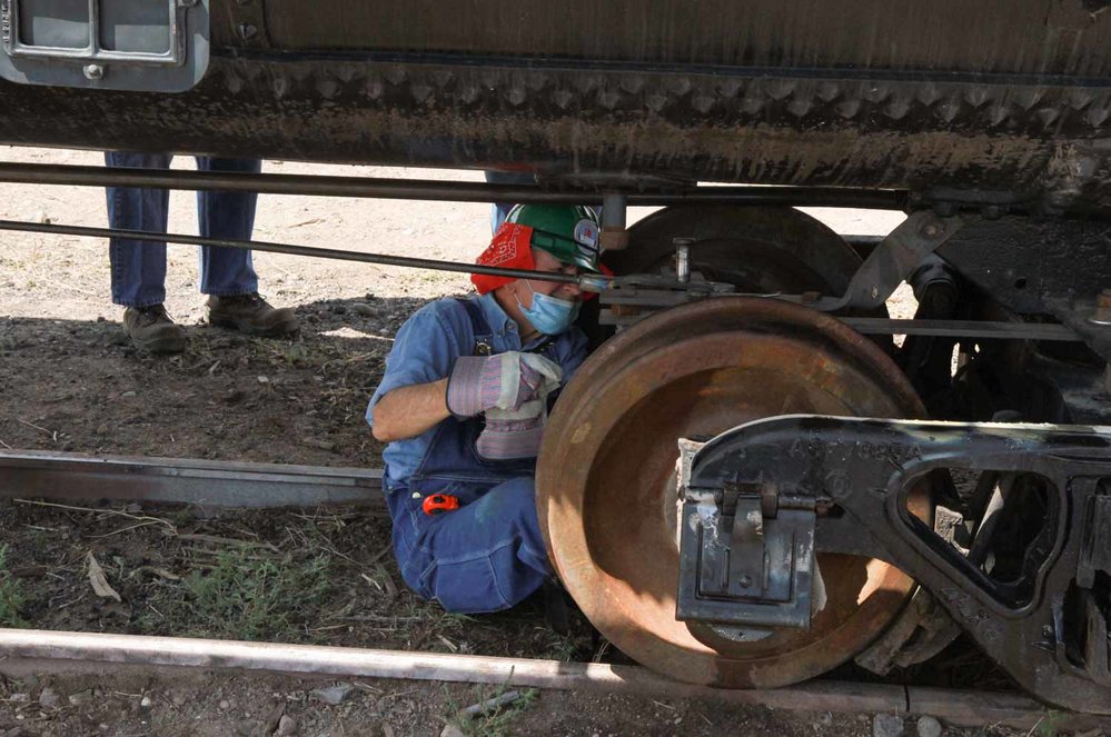 Working under the Union tank car on the brake rigging (1 of 1).jpg