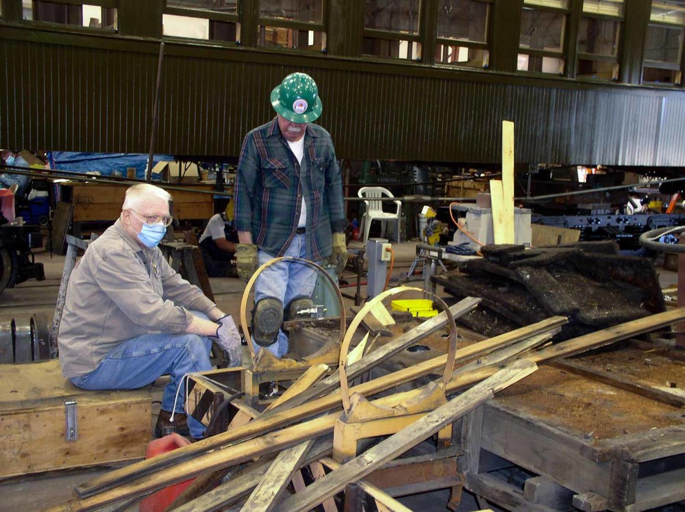 Two Friends looking at the pile of wood removed from MW02 (1 of 1).jpg
