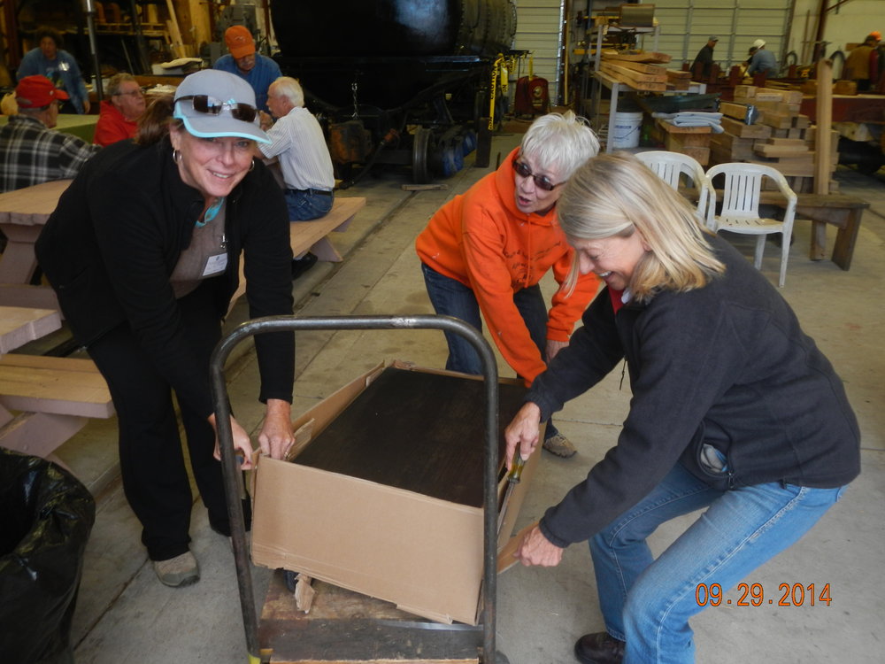 Some assembly required! Kay, Kathy and Valley make quick work of assembling hydraulic lift platform donated by John Cole.JPG