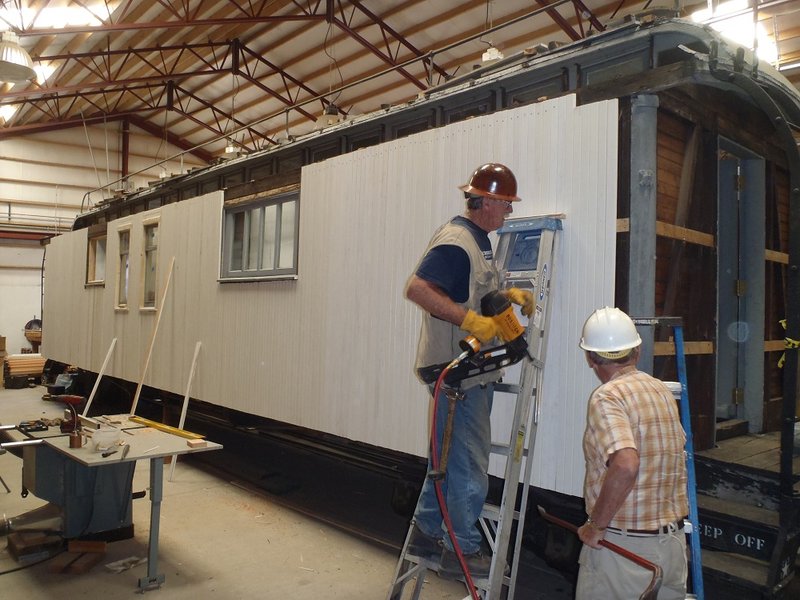 Friends' Chairman Craig McMullen and Paul Twomey (lst year volunteer) work on siding Cook Car 053.jpg