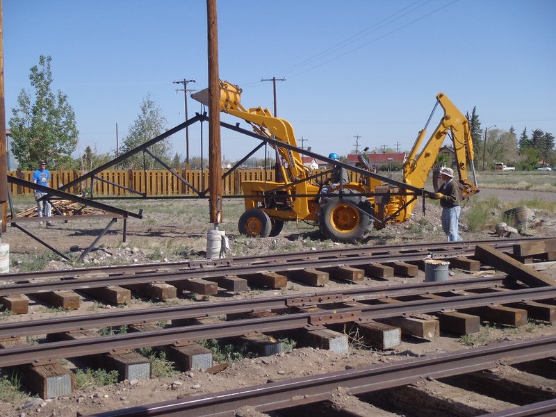 Jim Kyser and George Davies Assist Marshall Smith in Lifting Steel Truss.jpg