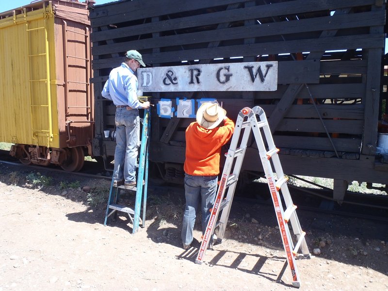 Fred Pittroff and Valley Lowrance letter display locomotive at entrance to Antonito rail yard.jpg