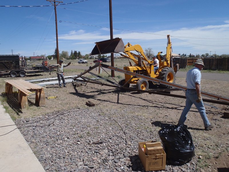 Rod Whelan and Tim Bristow guide driver Bob Reib in moving steel truss for car shelter.jpg