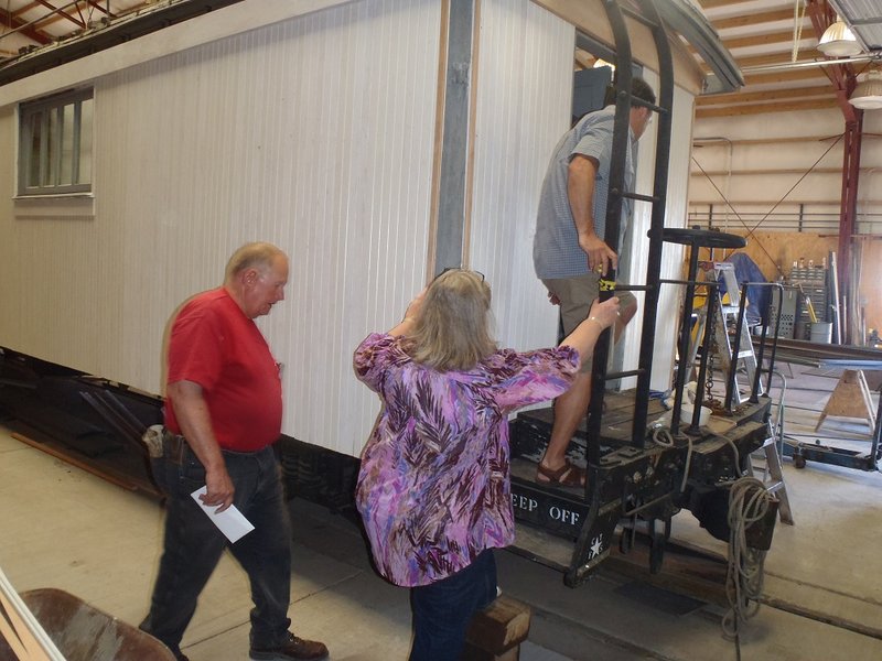 Projects Committee Co-Chair John Engs, Katharina Root and Patrick Wilkins see interior of Cook Car 053.jpg