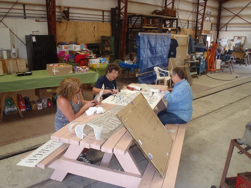 Maggie McMullen, Mary Jane Smith and Patty Hanscom clean stencils used for display train lettering project.jpg