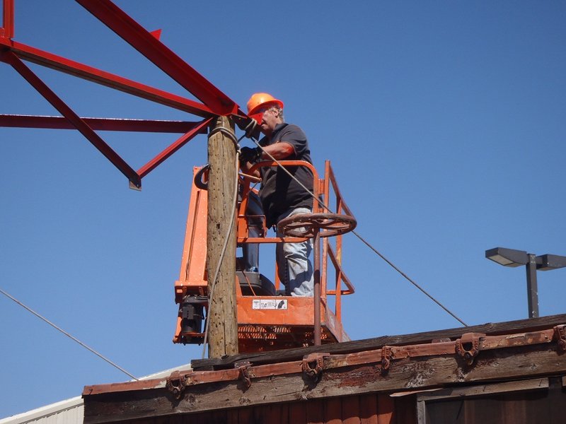 Bill Kepner puts in first bolt, connecting truss to post.jpg