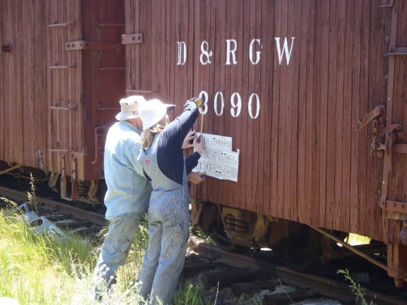 Team Leader Craig Kumler and Robin Kumler measure area where stencil is to be placed.jpg