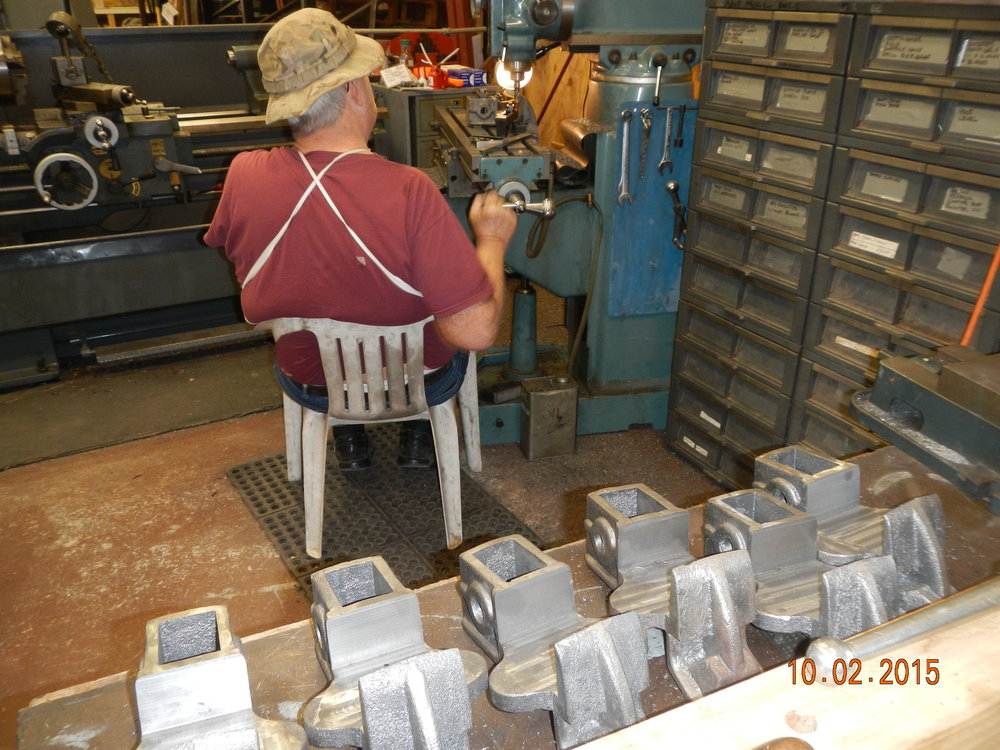 John Weiss machining new brake hangers seee them in the foreground.JPG
