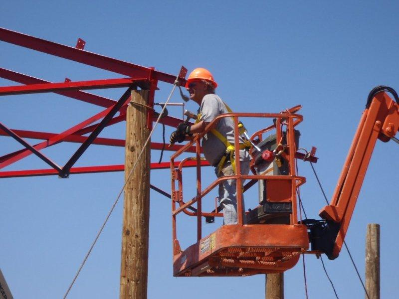 Bill Kepner gets ready to drill holes and bolt truss pair to post .png