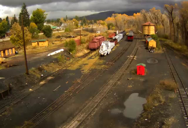 10.22.15 dark clouds hang over the mountains as a ray of sun hits the cars in north yard.jpg