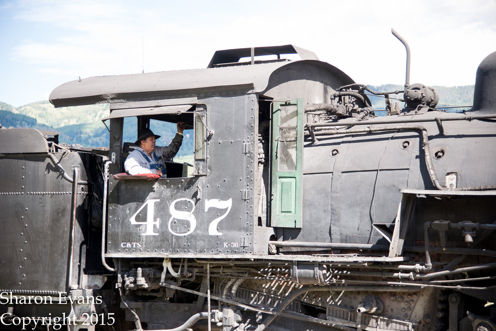 The engineer lays on the whistle as 487 comes over the crossing.jpg