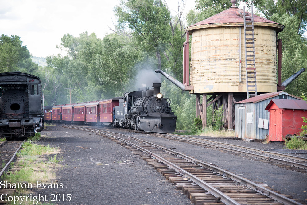 Train 215 comes by the water tower as it enters Chama yard.jpg